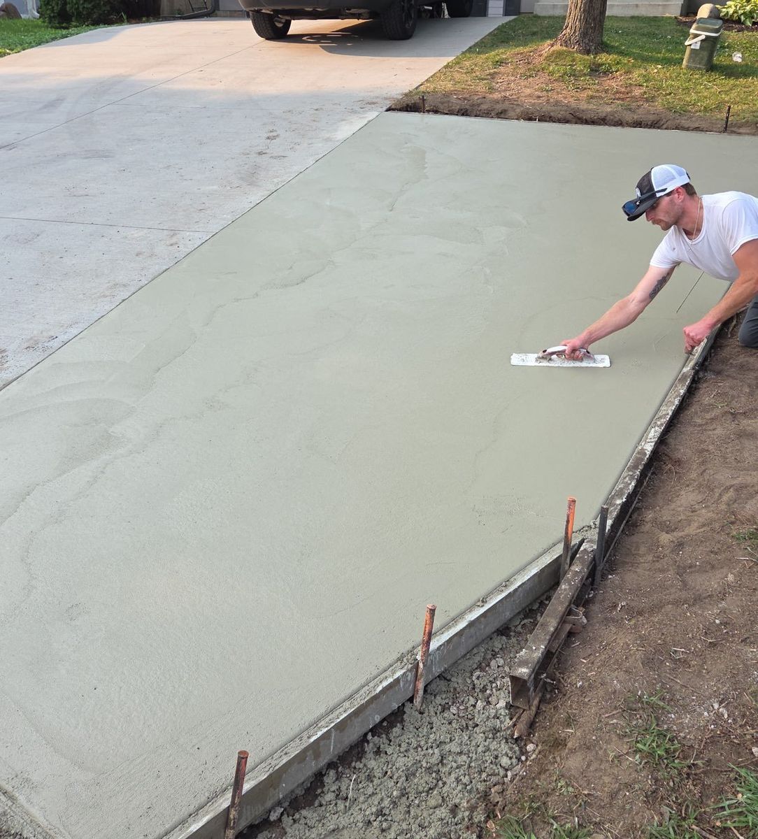 Hand troweling driveway extension
